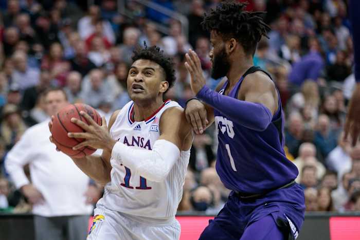 Mar 11, 2022; Kansas City, MO, USA; Kansas Jayhawks guard Remy Martin (11) drives around TCU Horned Frogs guard Mike Miles (1) during the second half at T-Mobile Center. Mandatory Credit: William Purnell-USA TODAY Sports